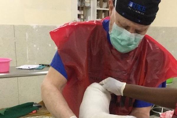 James Deorio puts a plaster cast on a patient