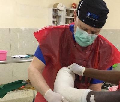 James Deorio puts a plaster cast on a patient