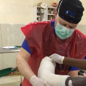 James Deorio puts a plaster cast on a patient